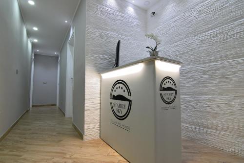 a white wall with two stickers on it in a hallway at Starry Sky Charming House in Alghero