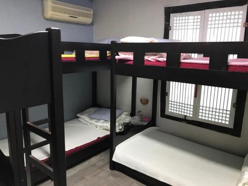 a group of bunk beds in a room at Guesthouse Nabiya in Chuncheon