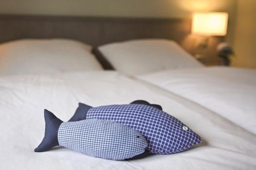 Postel nebo postele na pokoji v ubytování Hotel Landhaus Leuchtfeuer Nordseeinsel Pellworm