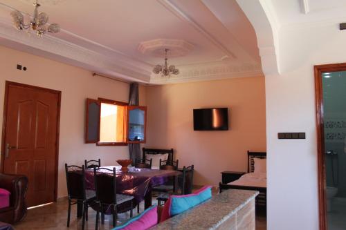 a dining room with a table and chairs at Hôtel Ajil Cascades D'ouzoud in Ouzoud