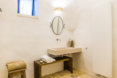 a bathroom with a sink and a mirror on the wall at Borgo Canonica in Cisternino