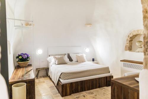 a small bedroom with a bed and a sink at Borgo Canonica in Cisternino
