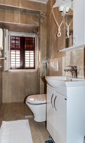 a bathroom with a toilet and a sink at Hotel Rendez Vous in Kotor