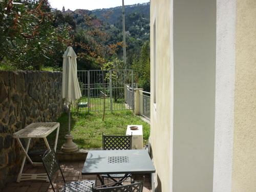 a patio with a table and an umbrella at Costa Morroni in Levanto