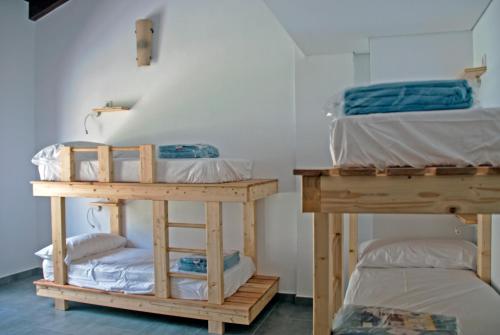 a room with two bunk beds and a table at Alberg Cal Manel in Saldés