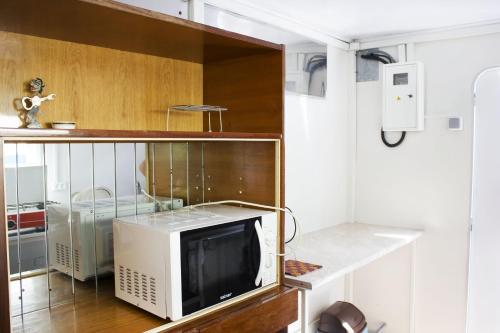 a microwave sitting on a counter in a kitchen at Dacha v Odesse in Odesa