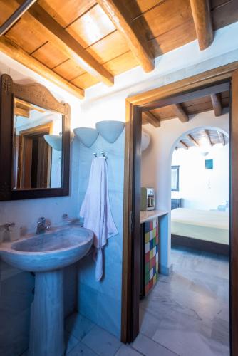 a bathroom with a sink and a mirror at Bleland Mykonos in Mikonos