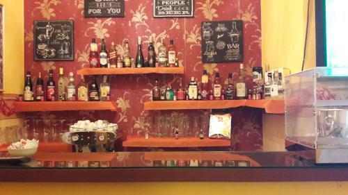 a bar with a bunch of bottles on the wall at Hotel Europa in Perugia