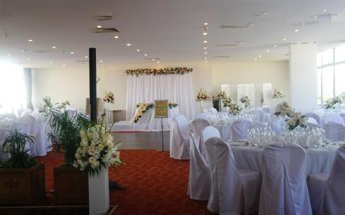 a room filled with tables with white table cloths at Carlton Madagascar in Antananarivo