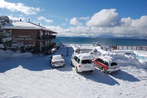 three cars parked in a parking lot covered in snow at Crown Motel in Kings Beach