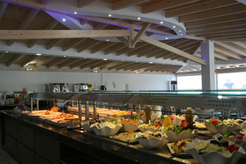 a buffet line with many different types of food at Saint George Palace in Perlopsimades