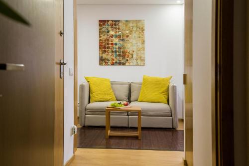 
a living room with a couch and a table at Spot Apartments Trindade in Porto
