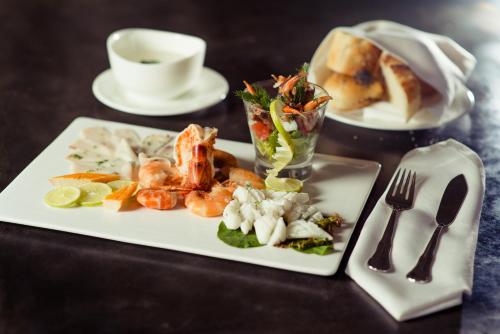 a plate of food with shrimp and vegetables on a table at Carlton Madagascar in Antananarivo