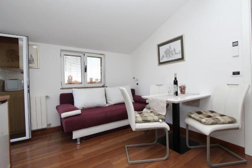 a living room with a couch and a table at Apartments Tanja in Rovinj