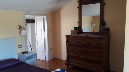 a bedroom with a dresser with a mirror on it at B&B Casa Laviano in Melfi