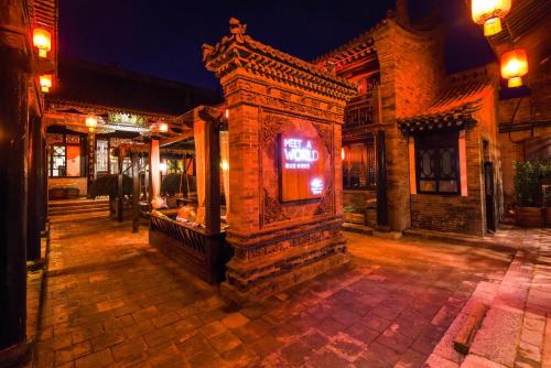 a building with a sign that says bar at night at Elsewhere Hotel The former residence of the draft bank in Pingyao