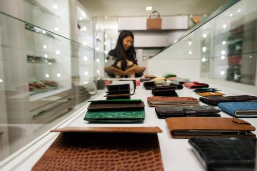 a woman in a store looking at a display case with cell phones at Carlton Madagascar in Antananarivo