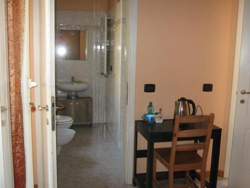 a bathroom with a toilet and a sink at Albergo Sangalli in Boario Terme