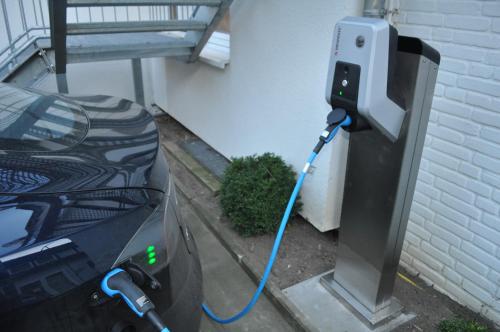 a electric car is plugged into a pay phone at Akzent Hotel Haus Surendorff in Bramsche