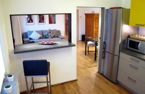 a kitchen with a living room and a kitchen with a refrigerator at Komfortwohnung City/Messe 25 Min in Cologne