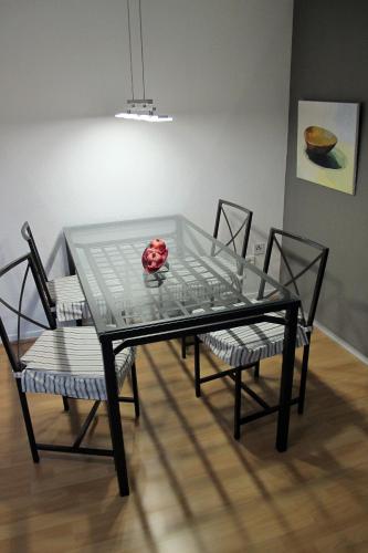 a glass table with two chairs and a bowl on it at Komfortwohnung City/Messe 25 Min in Cologne