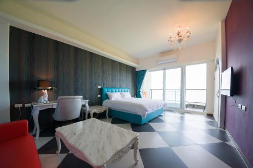 a bedroom with a bed and a desk and a television at Whitecaps B&B in Yanliau