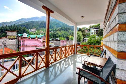 a balcony with a view of a city at Dragon Inn in Manāli