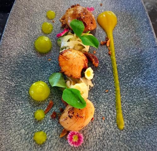 a plate of food with vegetables and a spoon at The Bath Arms Hotel in Cheddar