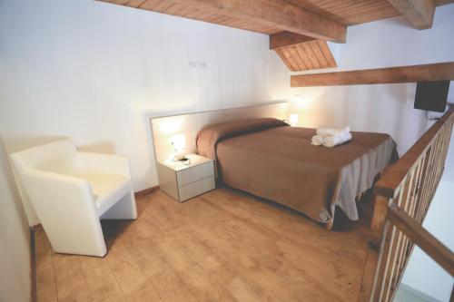 a small bedroom with a bed and a staircase at IL VIAGGIATORE VIA INDIPENDENZA B&B in Gaeta