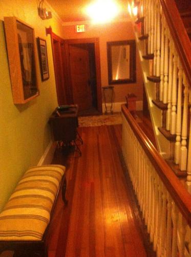 a living room with a staircase and a couch at The John Randall House in Provincetown