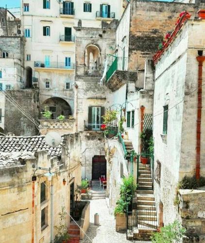 a view of an old building with stairs and buildings at Giardini 82 B&B in Gravina in Puglia