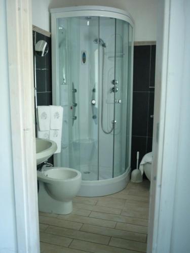 a bathroom with a shower and a toilet and a sink at Costa Morroni in Levanto