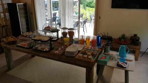 a wooden table with food on top of it at Villa Perle De La Mer in Saint-Aygulf