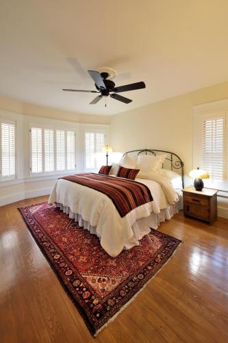 a bedroom with a bed and a ceiling fan at Casa Culinaria - The Gourmet Inn in Santa Fe