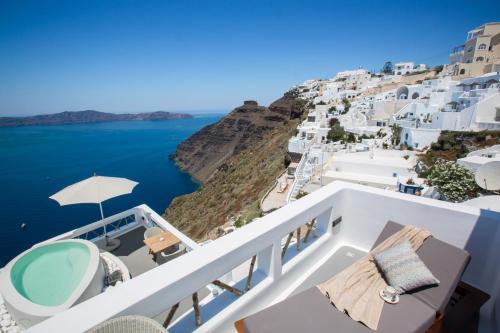 a large white boat sitting on top of a cliff at Chic Hotel Santorini in Firostefani
