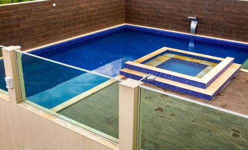 an overhead view of a swimming pool with a glass floor at Executivo Flat II in Parauapebas