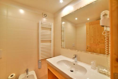 a bathroom with a sink and a mirror at Albergo Stelvio in Bormio