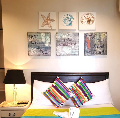 a bedroom with a bed with posters on the wall at Bayview Country Inn El Nido in El Nido