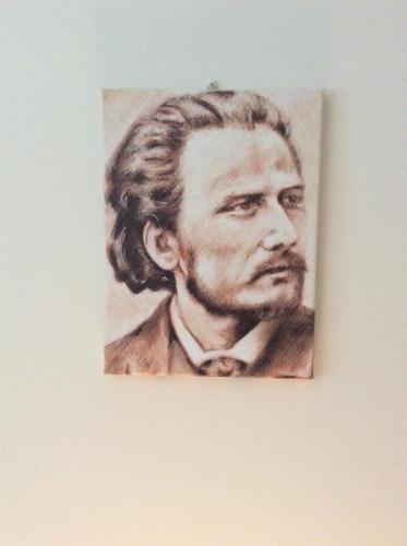 a drawing of a man with a beard on a wall at B&B Notte sul Lago in Gozzano