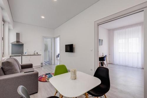 a living room with a couch and a table at Ovar Apartments by Aqualeisure in Ovar