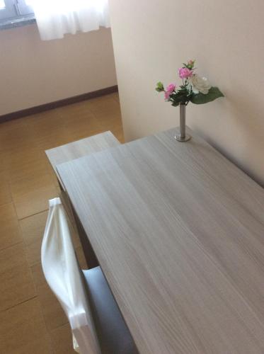 a table with a vase of flowers on top of it at B&B Notte sul Lago in Gozzano