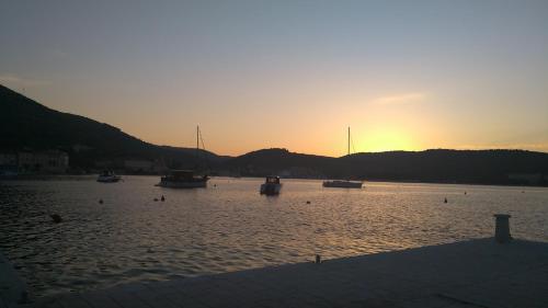 a group of boats in the water at sunset at Apartment II Radisic beautiful view in Vis