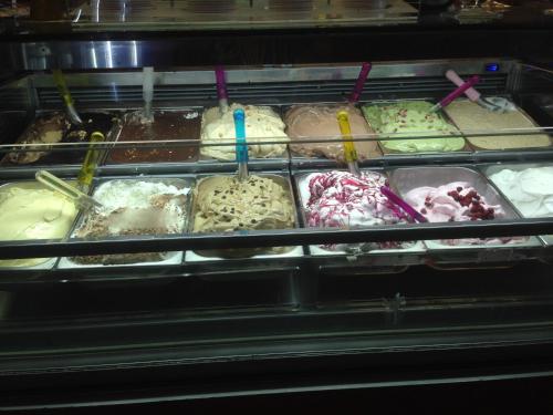 a display case filled with different types of ice cream at Colapesce in Santa Teresa di Riva