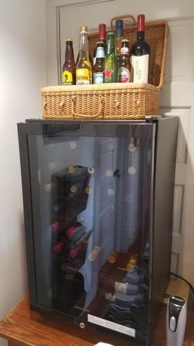 a television with bottles of alcohol on top of it at First Colony Inn in Nags Head
