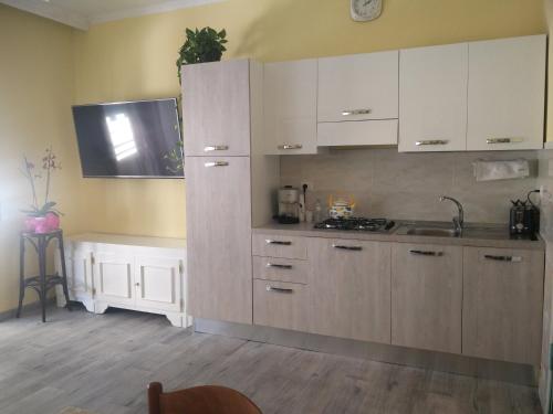 a kitchen with white cabinets and a sink at Julia B&B in Crotone
