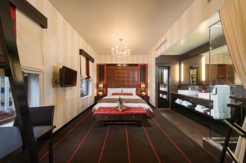 a large bedroom with a bed and a bathroom at Sanctuary Hotel New York in New York