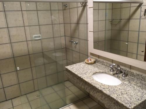 a bathroom with a sink and a shower at Farina Park Hotel in Bento Gonçalves