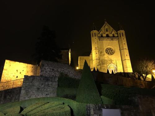 a large building with a clock tower at night at Les Maisons du Périgord in Terrasson-Lavilledieu