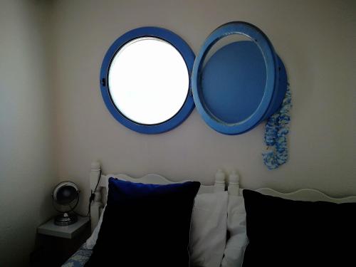 a bedroom with a mirror on the wall and a bed at La Casa di Nina in La Maddalena