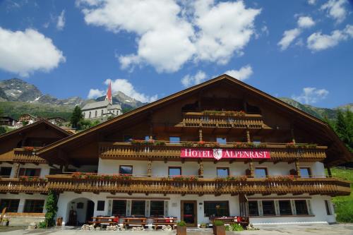 a building with a sign on the front of it at Hotel Alpenrast in Riva di Tures